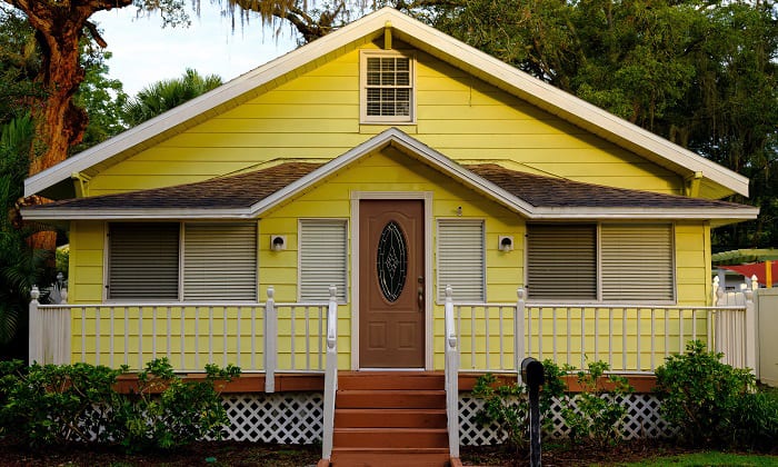 dark-natural-wood-front-door-color-for-yellow-house