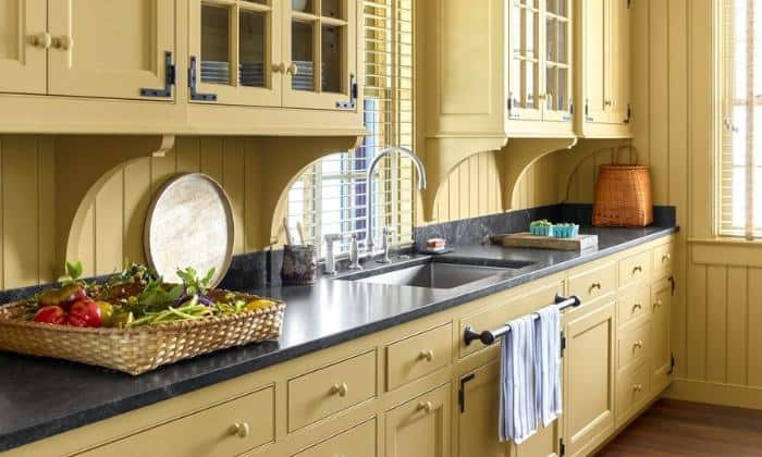 yellow-cabinets-with-black-granite-countertops